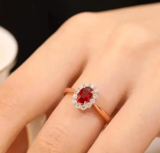 Gold Pigeon silver-plated ring with red blood gemstone and flower pattern, side view on white background