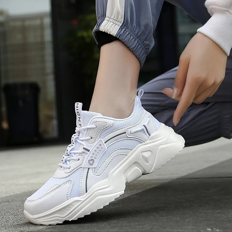 White women's thick-soled casual trainers with mesh upper and buckle detail