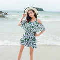 Women's green leaf style printed one-piece swimsuit laid flat.