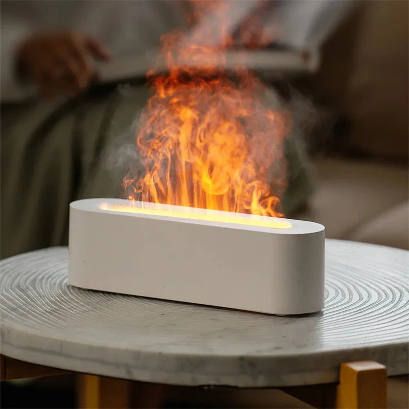 White square ultrasonic flame aroma diffuser and humidifier with LED light on a table.