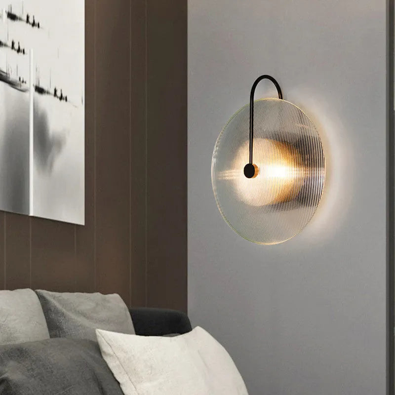 Round glass wall lamp in gold finish with glass shade and iron body for bedside or aisle lighting