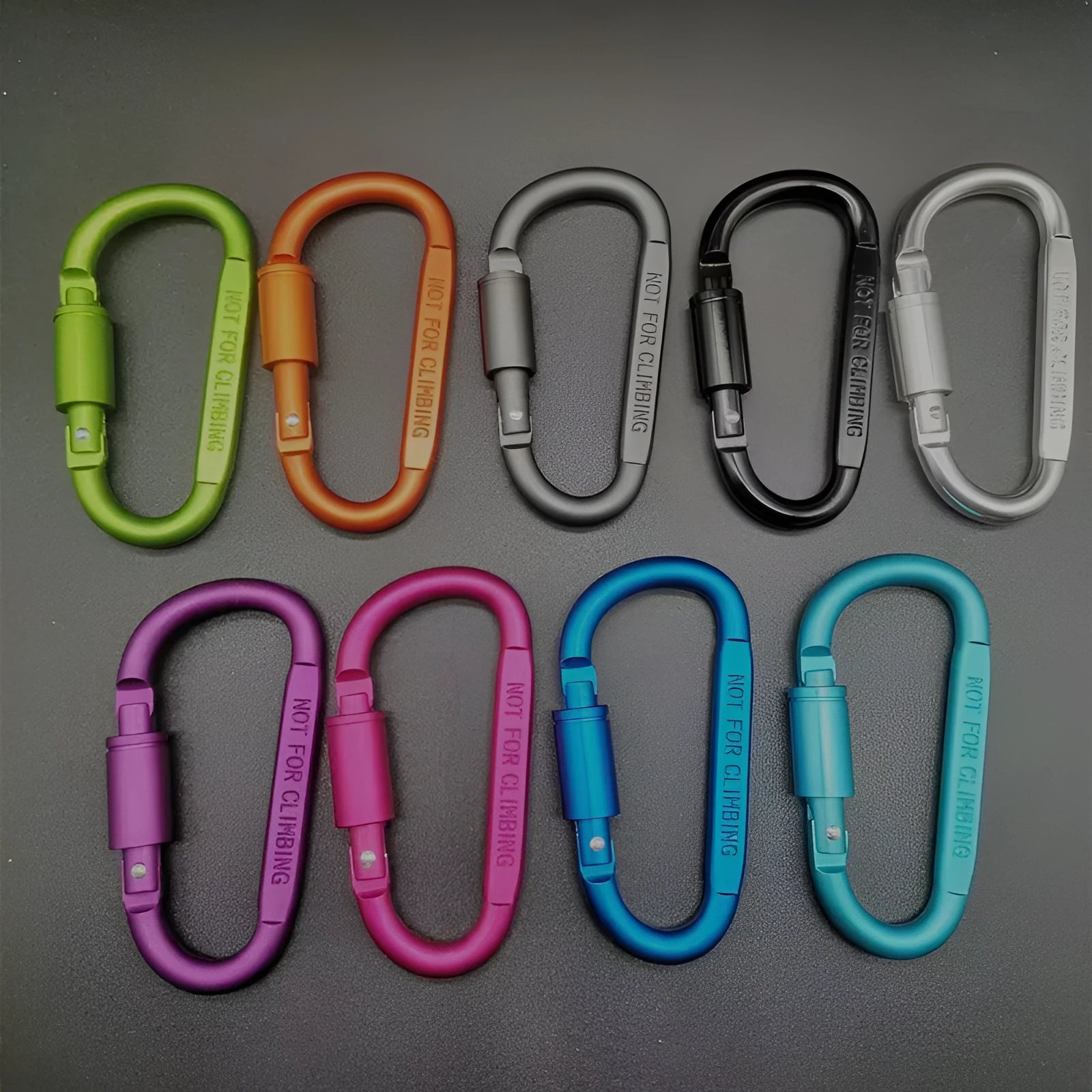 Silver D-shaped aluminium locking carabiner with an 8cm profile on a grey background.