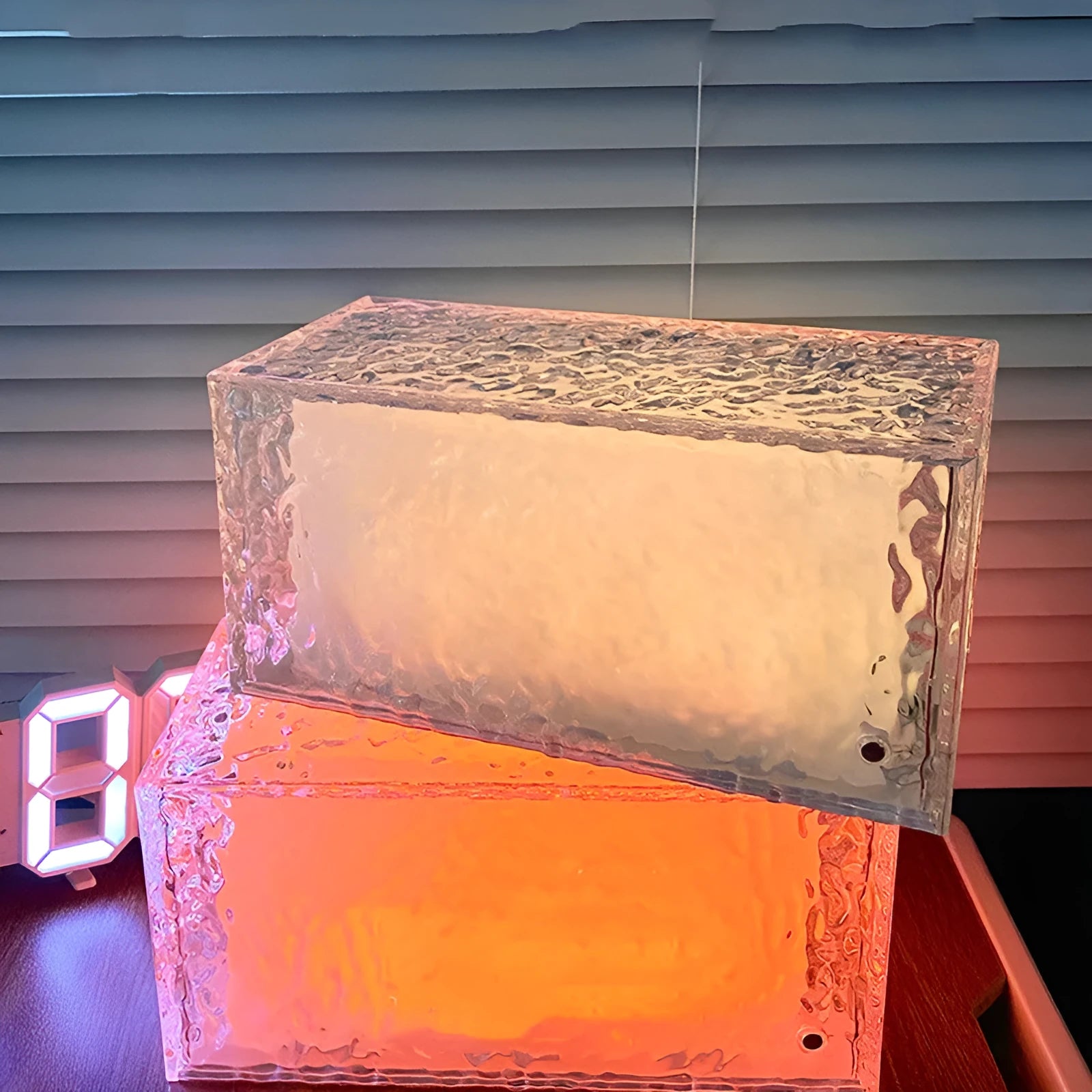 Geometric ice cube shaped acrylic night lamp with colour changing lights on wooden surface