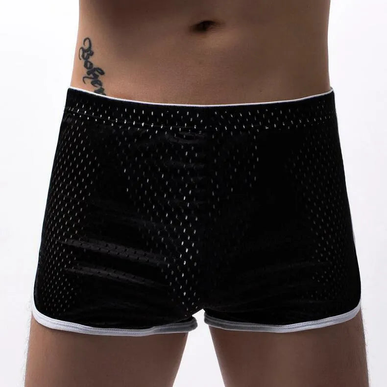 Men's black three-point boxer shorts made from a knitted cotton and nylon blend on a plain background.