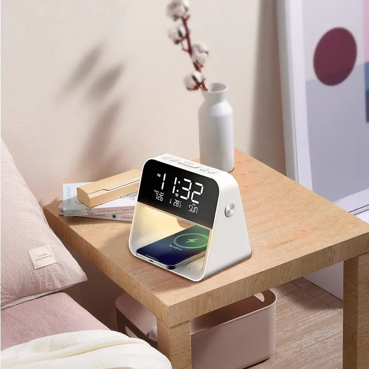 White multifunctional bedside lamp with wireless mobile phone charger and alarm clock on a nightstand