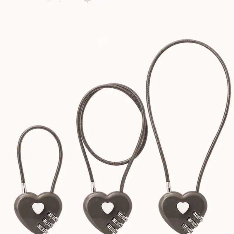 Peach Heart shaped wire rope lock in ABS plastic for securing bicycle helmets.