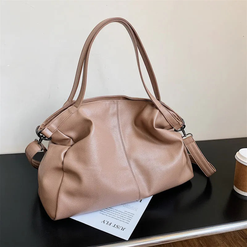Soft surface messenger shoulder bag in horizontal square shape with zipper opening and internal compartments
