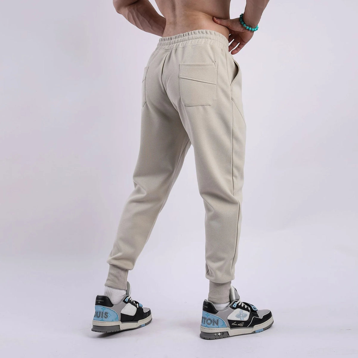 Men's ankle-tied drawstring sweatpants in polyester cotton, available in five colours and sizes M to XXXL