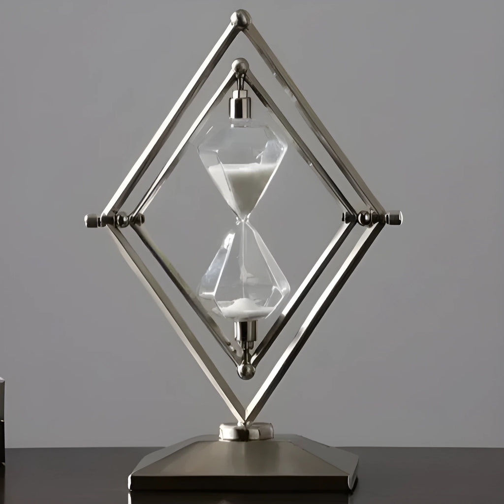 Glass sand clock timer with detailed metal ornaments in a bronze finish, showing modern simplicity style.