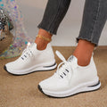 Women's black mesh lace-up flat pumps with round toe and rubber sole on white background
