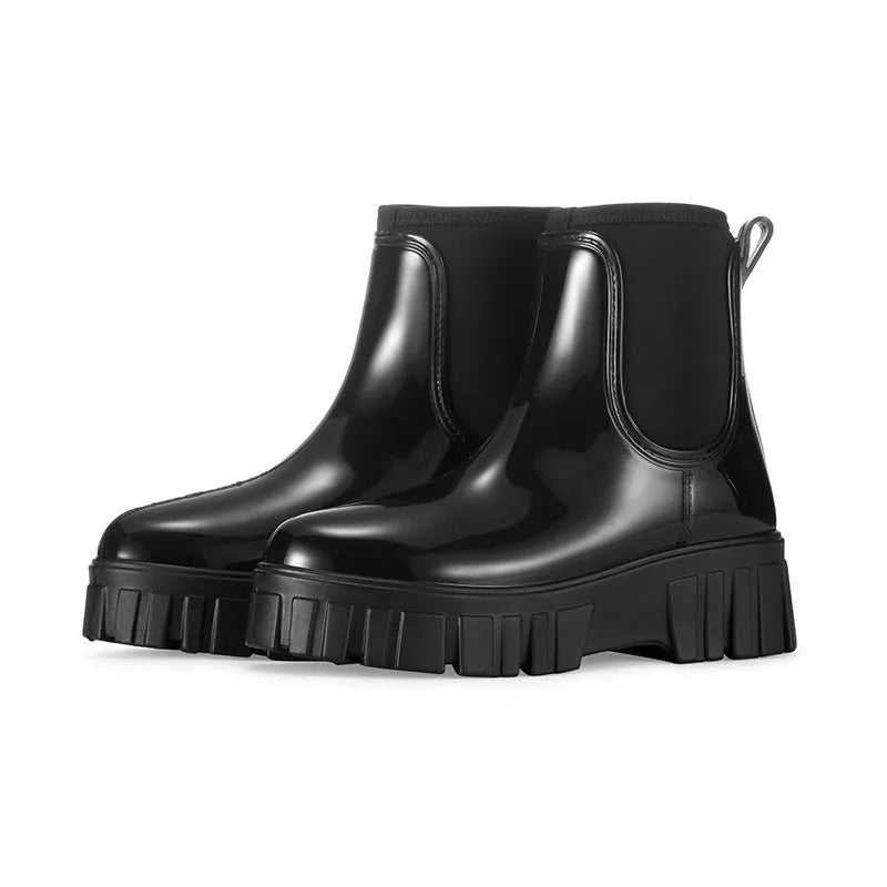 A pair of low tube PVC rain boots with a flat heel, shown in a solid colour on a white background.
