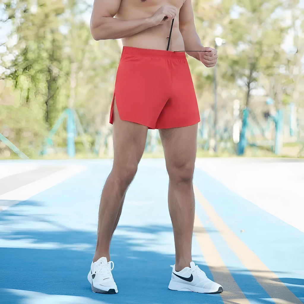 Men's red off-road running shorts with a high waist and loose fit, shown for marathon and cross-country running.