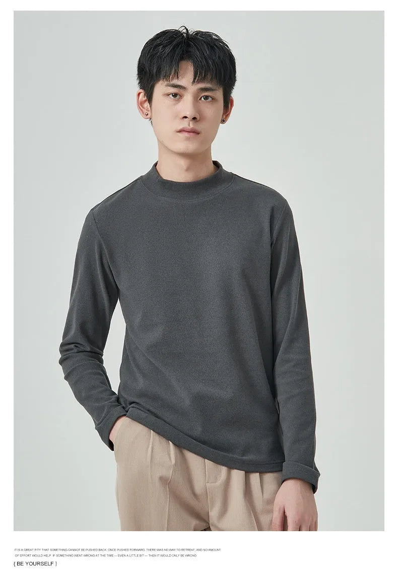 Men's brown Dralon fabric long sleeve t-shirt with a half-high collar on a hanger.