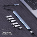 Blue USB-C 7-in-1 docking station with seven USB ports and 0.1m cable on a desk