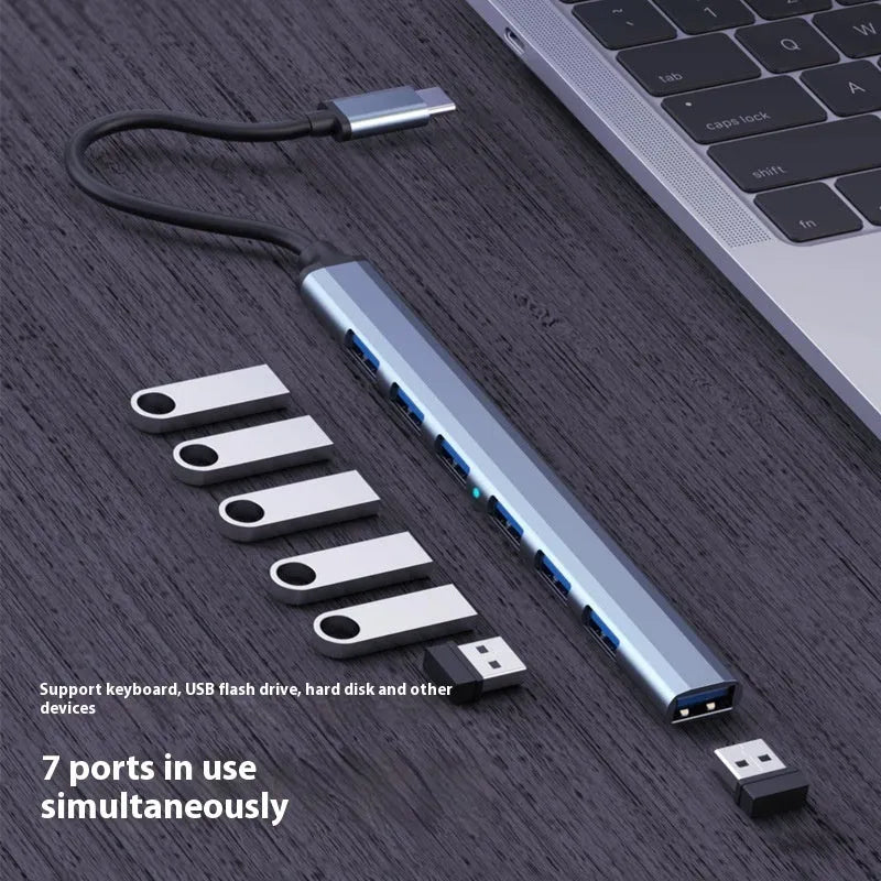 Blue USB-C 7-in-1 docking station with seven USB ports and 0.1m cable on a desk