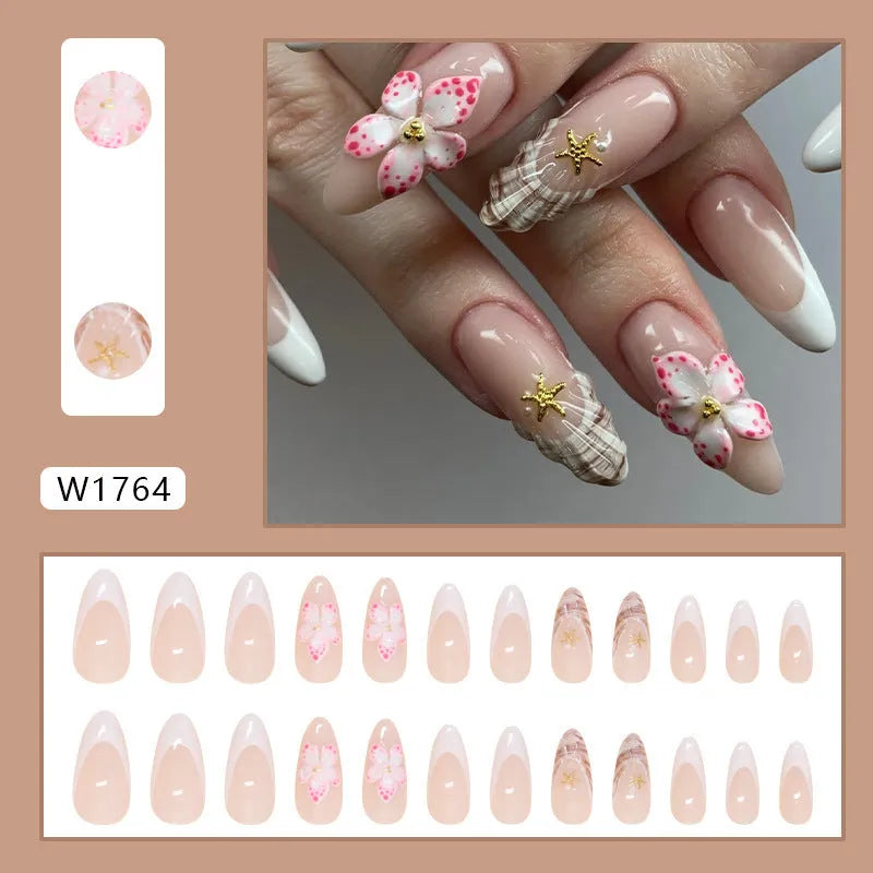 French style fake nails with simple flower pattern in a plastic kit including glue.