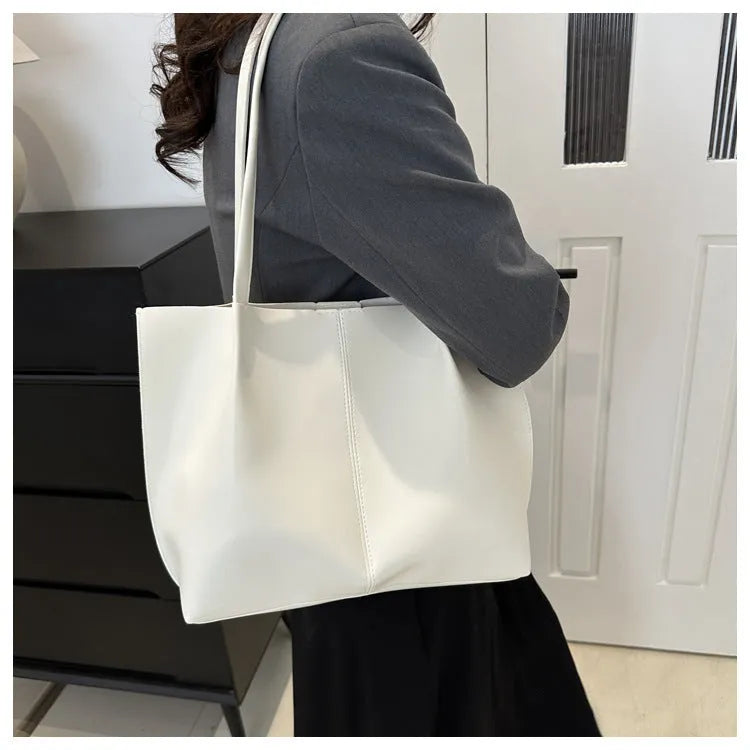 Casual messenger bag in PU leather with stitched detail, bucket shape, double shoulder straps, available in black brown coffee white