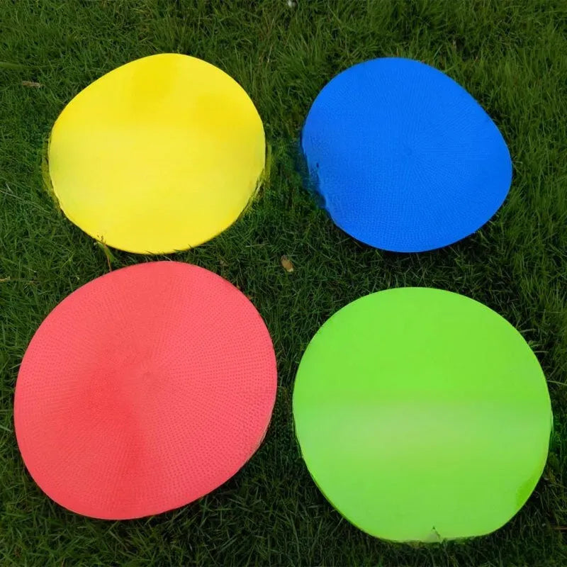 23cm diameter football training landmark pad in bright colours on grass field