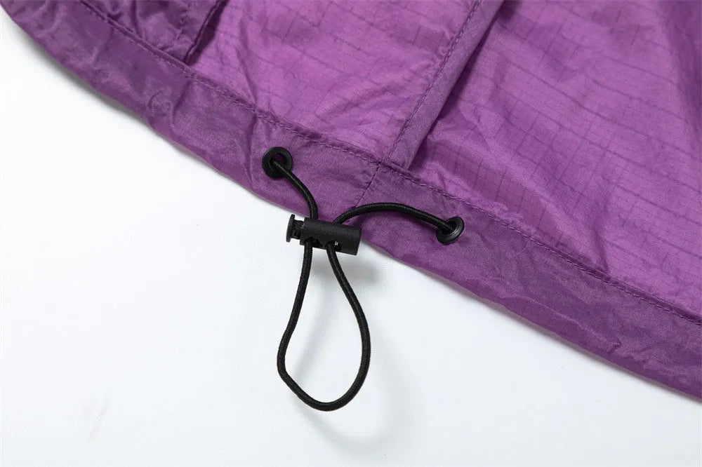 Men's thin loose sun protection jacket in black nylon fabric with pockets, worn casually outdoors