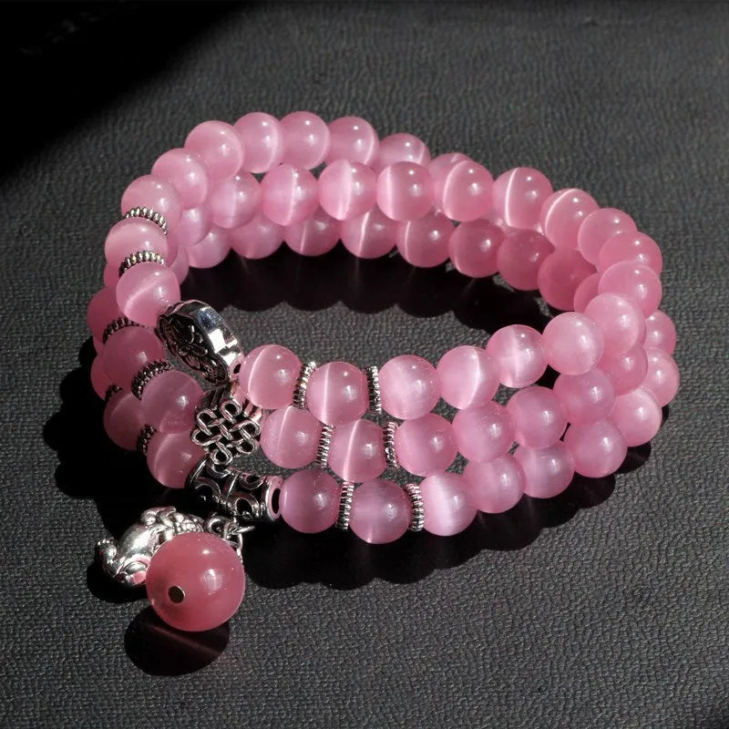 Opal crystal cat eye bracelet with lucky cat charm, shown in one of six colour options.