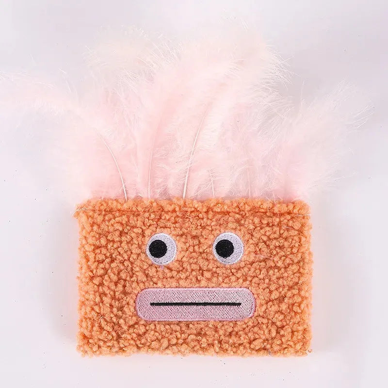 Colourful catnip plush toy with a funny big mouth explosion head shape on a blue background.
