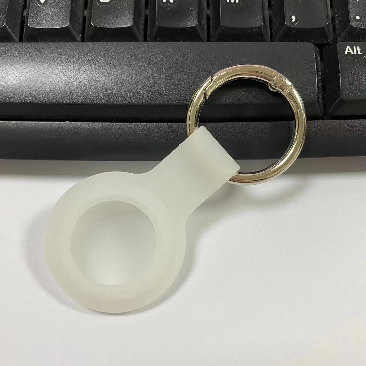 Silicone protective case with metal keychain snap for Apple AirTag in multiple colours.