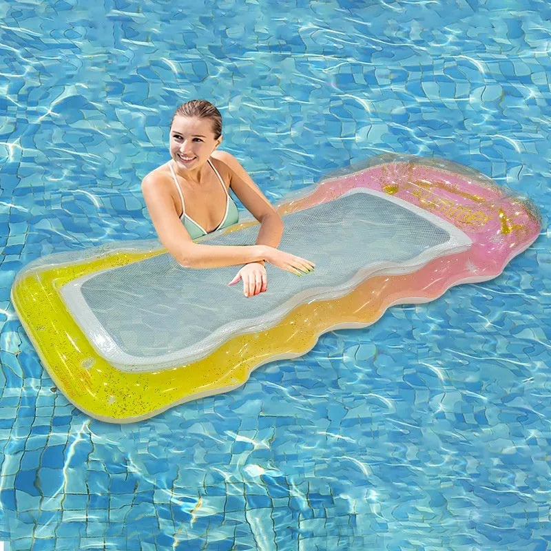 Inflatable floating row in sequined gradient colours on water, with canopy and mesh deck chair