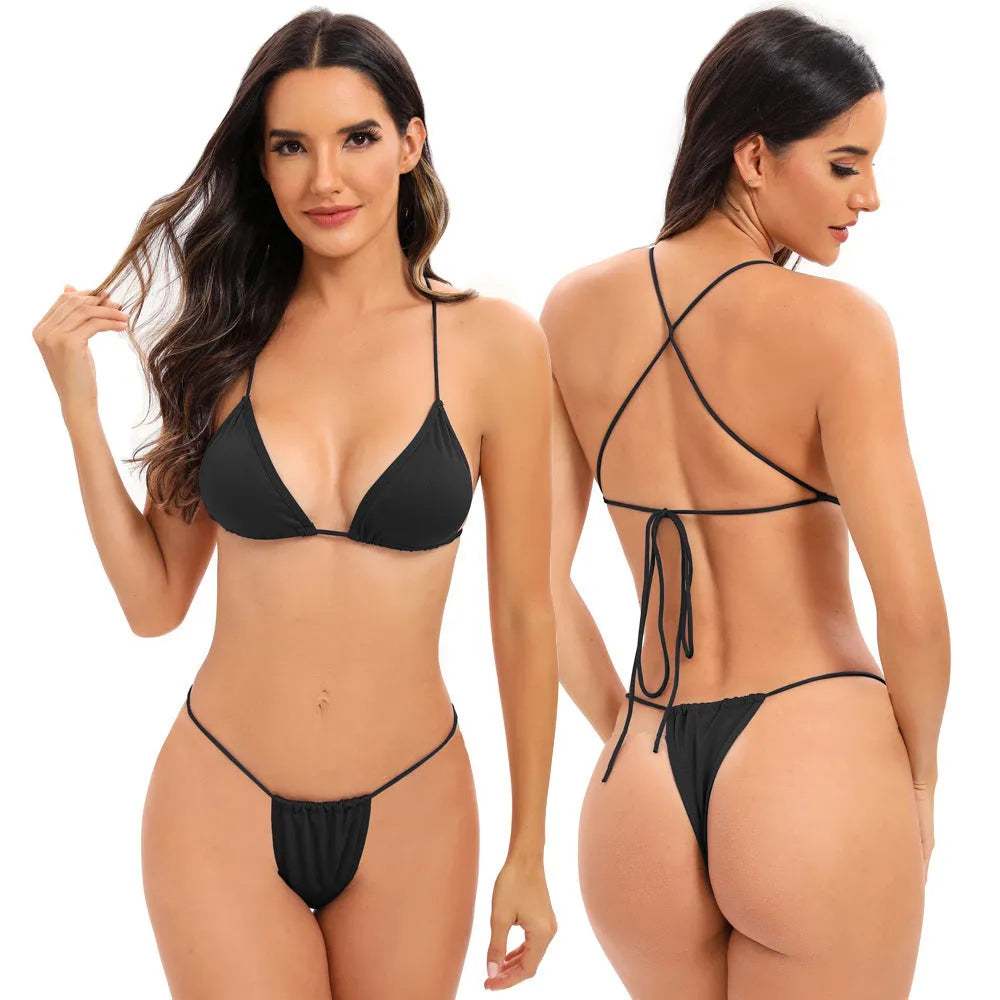 Women's striped one-piece swimsuit with cross-strap back, shown in a candy colour.