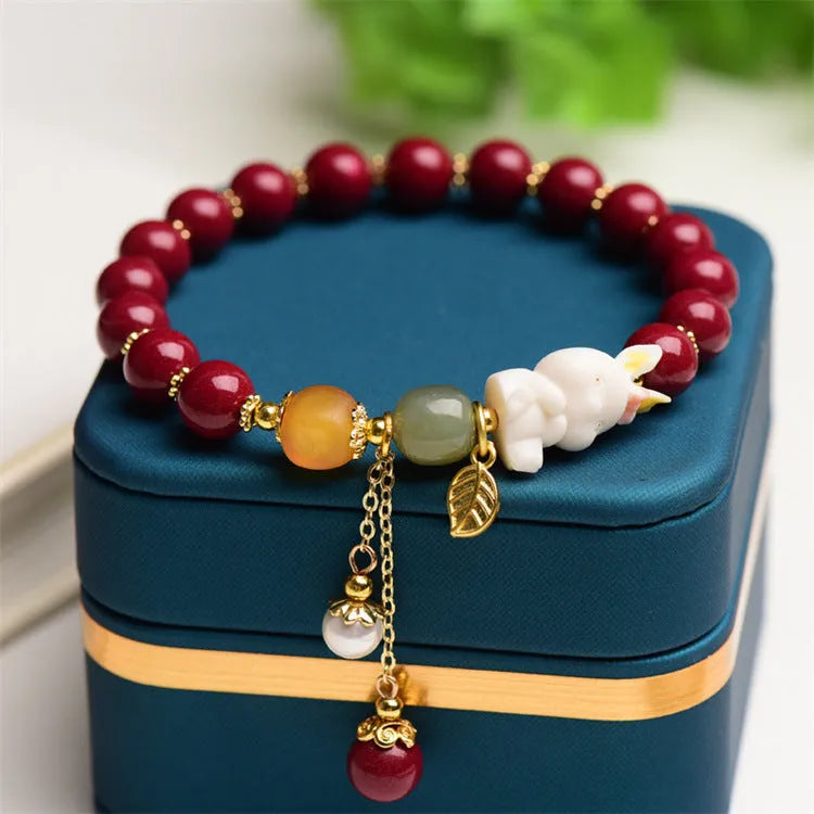 Tian Yu natural cinnabar bracelet with rabbit motif in purple gold sand colour
