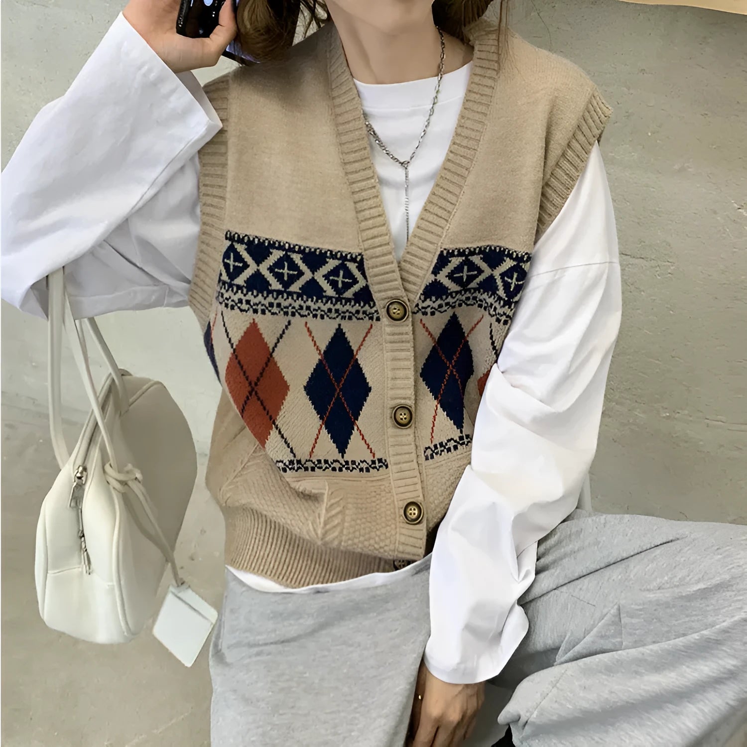 Loose diamond plaid sleeveless cardigan top in khaki colour showing pattern detail