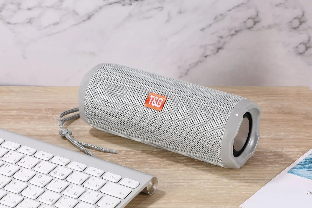 Fabric portable Bluetooth speaker with integrated card holder in multiple colour options.