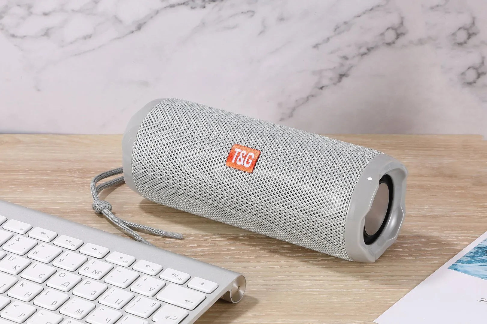 Fabric portable Bluetooth speaker with integrated card holder in multiple colour options.