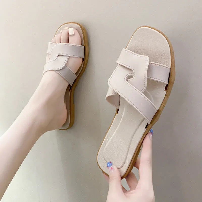Women's PVC cross strap flip flop sandals in light blue on a white background.