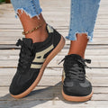 A pair of retro-style low-top lace-up sneakers in a selected colour on a plain background.