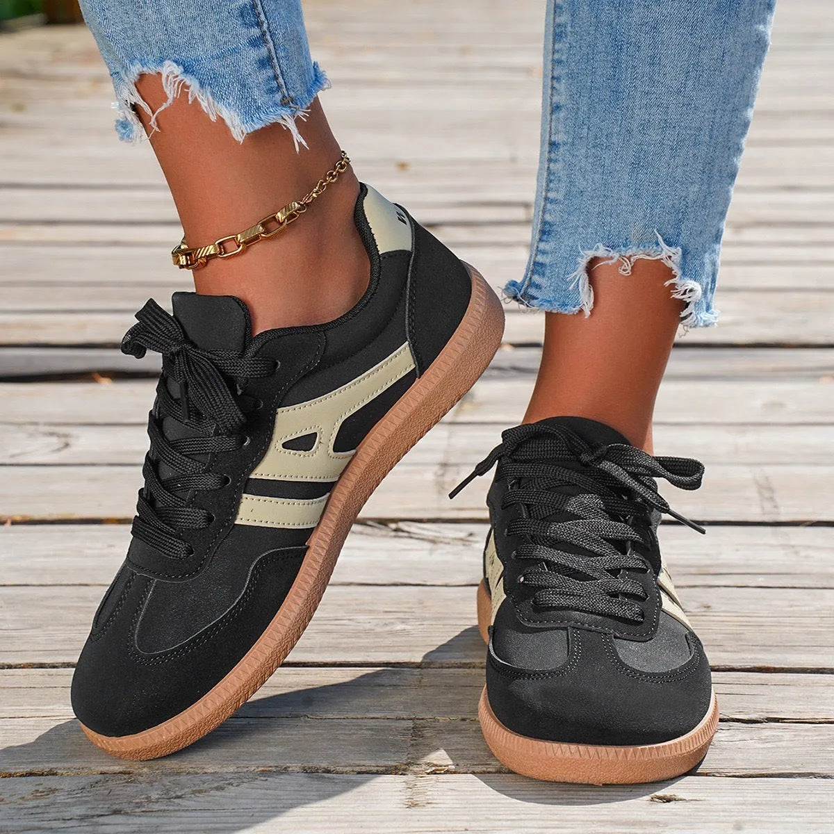 A pair of retro-style low-top lace-up sneakers in a selected colour on a plain background.