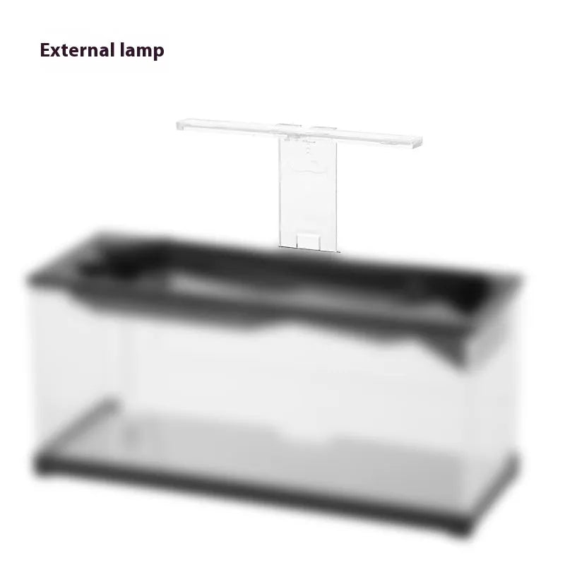 Small acrylic lazy aquarium with integrated filter, water pump, built-in lamp, heating mat, and external light on a desk