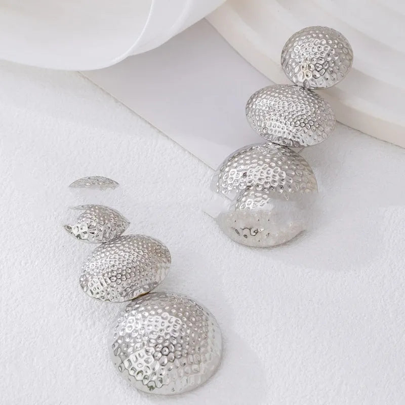 Retro women's polka dot metal bead drop earrings in frosted gold finish on a neutral background