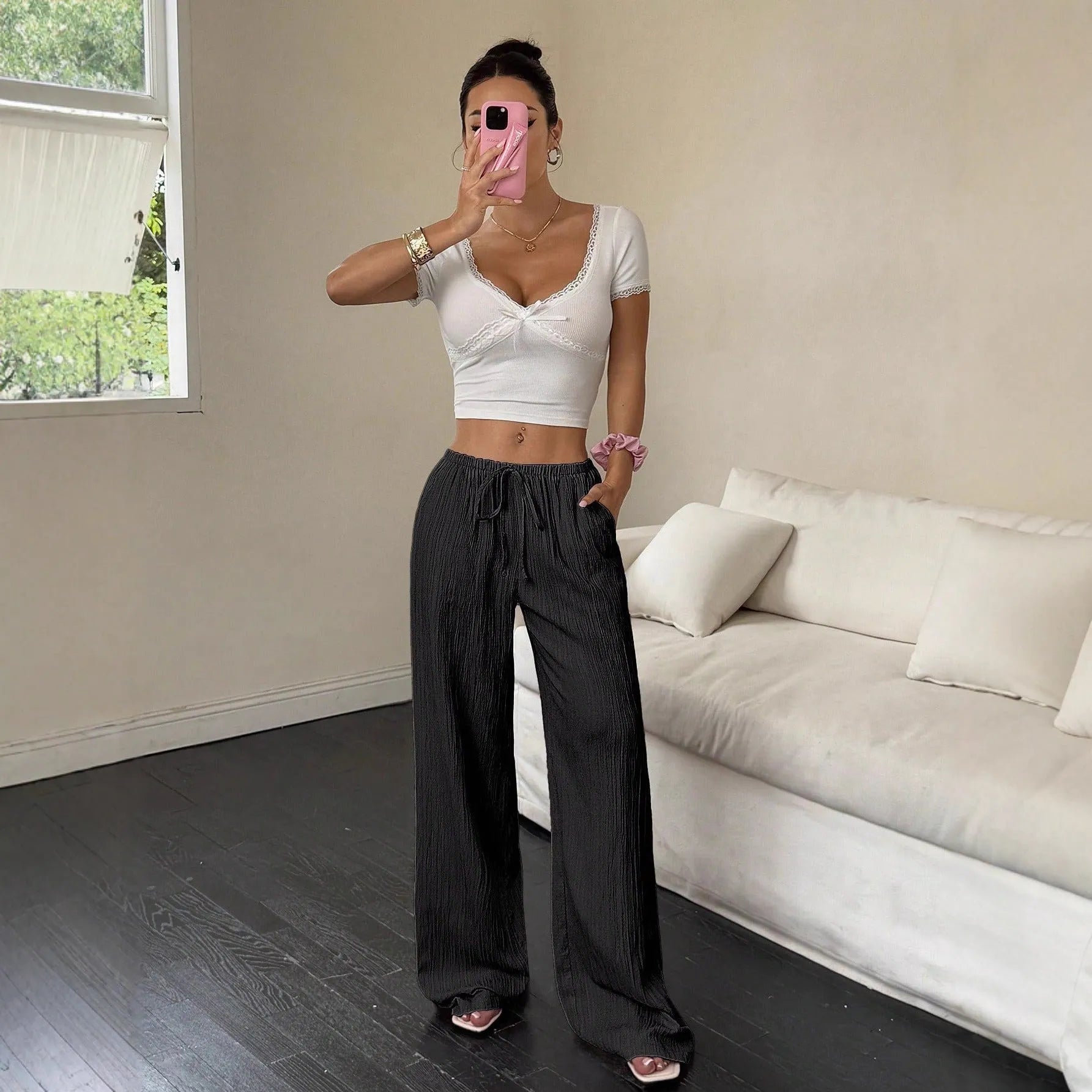 Women's black wide leg trousers with a front lace-up detail on the mid waist.