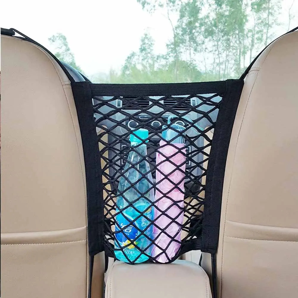 Black elastic nylon car pet fence isolation net installed on middle seat with hooks.