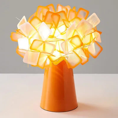 Nordic style decorative table lamp with metal base in a choice of colours on a bedside table.