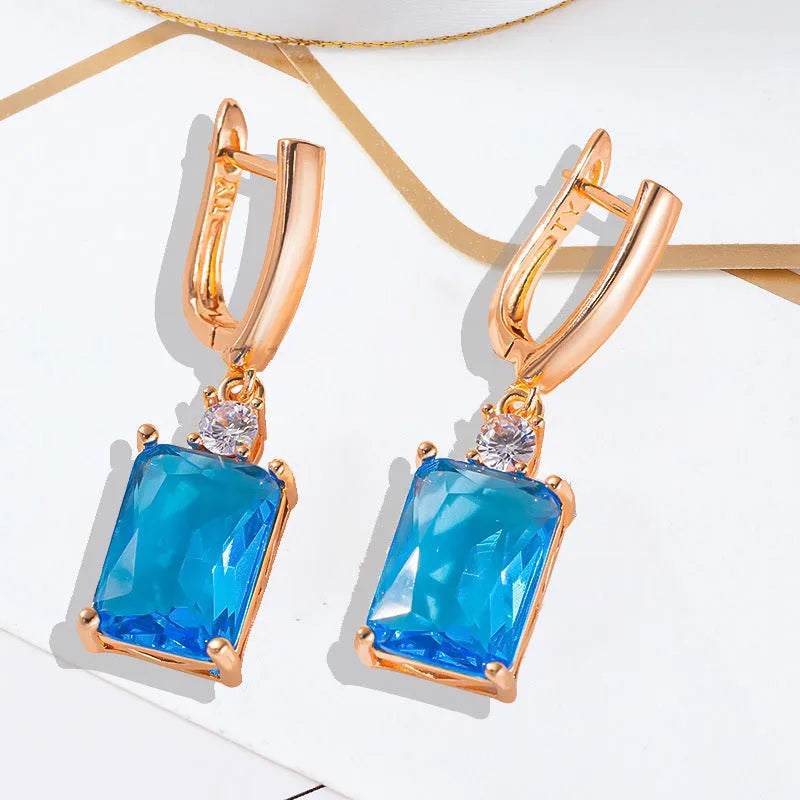 Square copper earrings with electroplated gold or silver finish and quadrilateral geometry