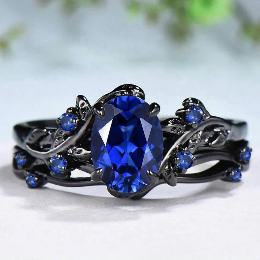 Geometric gun black women's couple ring with a navy blue rhinestone inlay on a copper band.