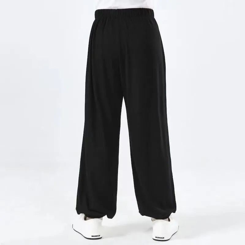 Children's black high elasticity Sanda practice pants made from Lycra fabric for martial arts training.
