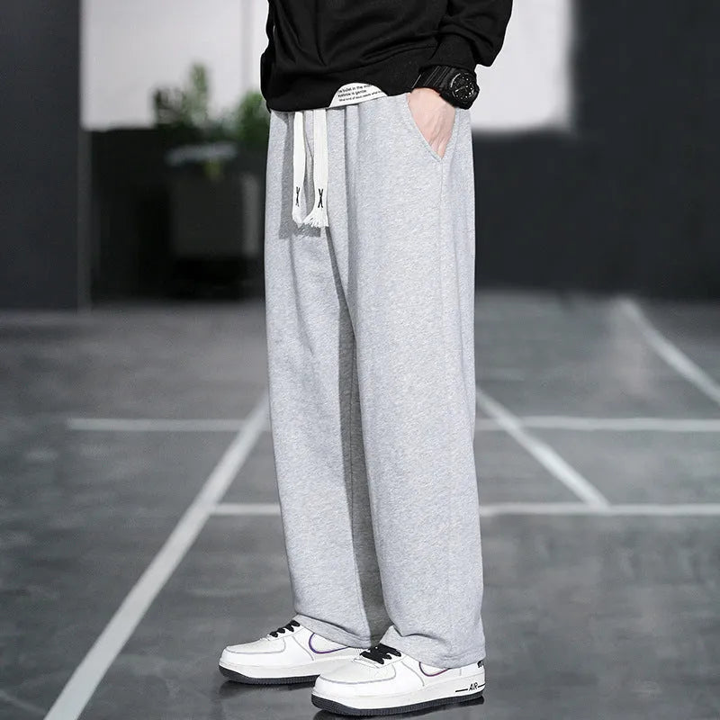 Casual grey men's sports trousers with multiple pockets and a high-waist design.