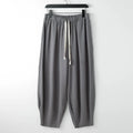 Men's linen harem pants with ankle ties in tapered loose fit on larger model
