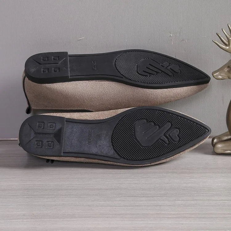Beige leopard print women's pointed toe pumps on a white background.