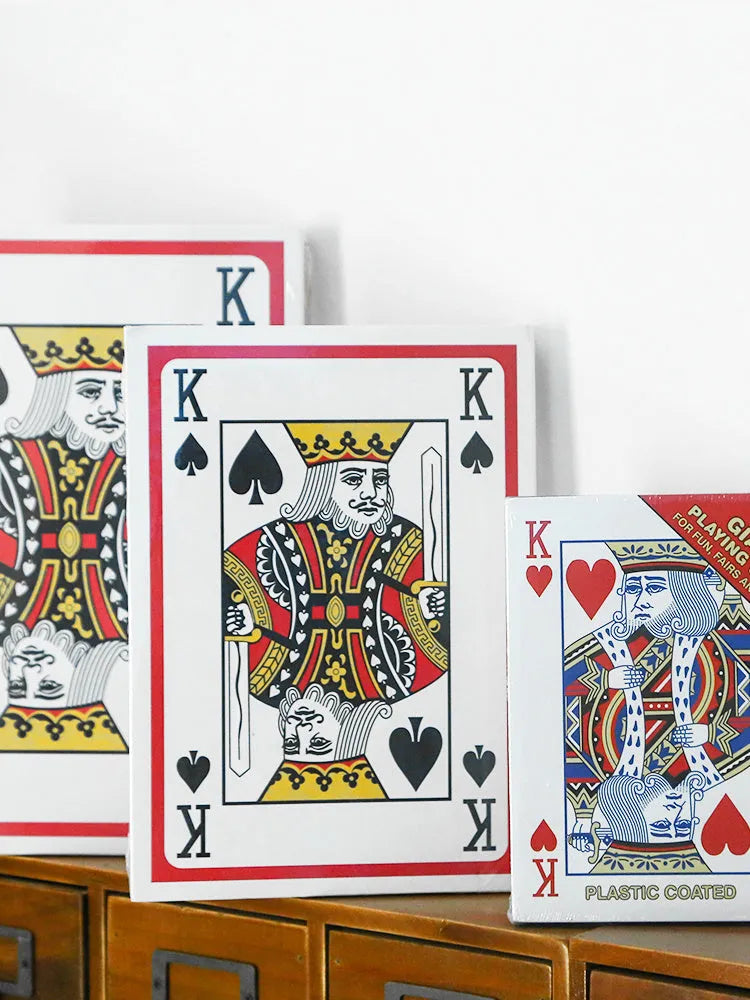 Set of oversized large size paper playing cards laid out on a table, showing the full 54-sheet deck.