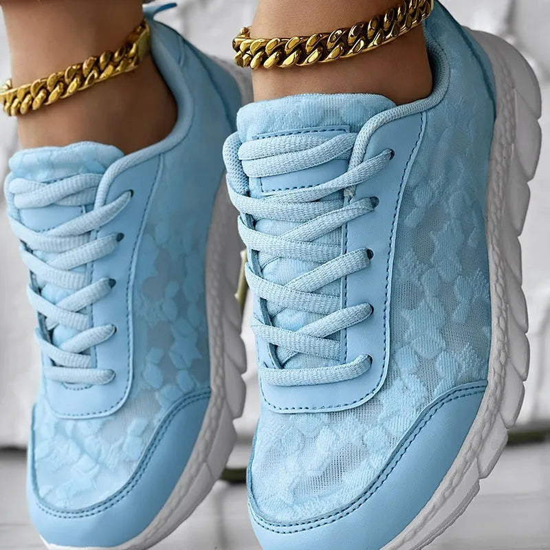 Women's canvas sports shoes in white colour showing flat heel design and round toe shape