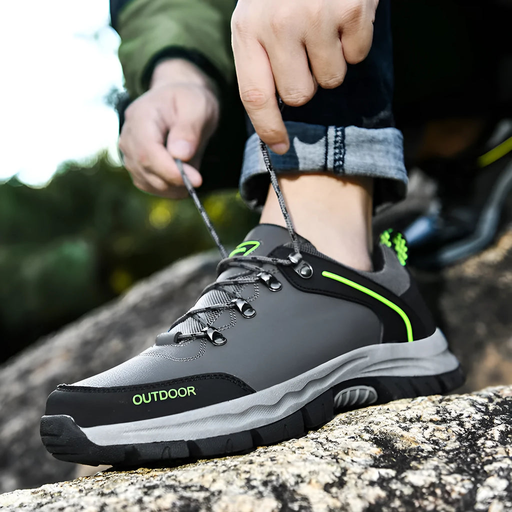 Men's black hiking shoes with synthetic leather upper and non-slip TPR outsole on outdoor trail