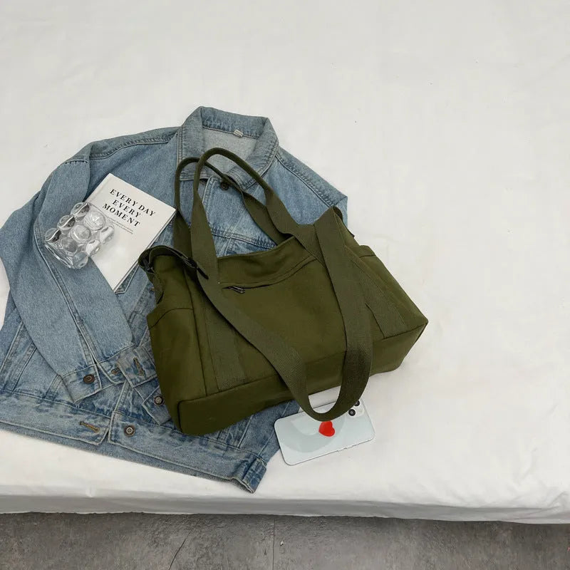 Large capacity polyester canvas shoulder tote bag in a solid colour, showing outer sandwich pocket.